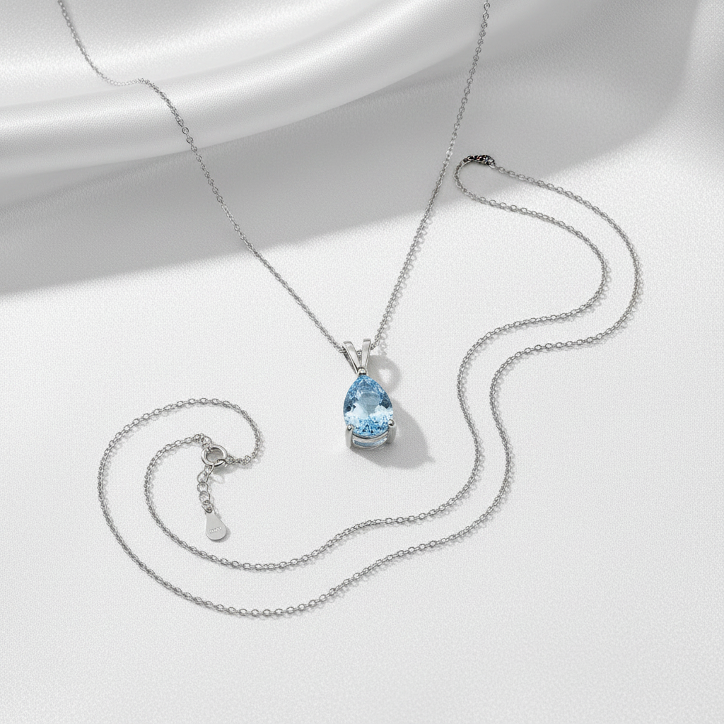 Aquamarine pendant flat lay silk